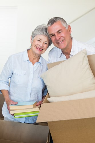 Elderly couple packing boxes